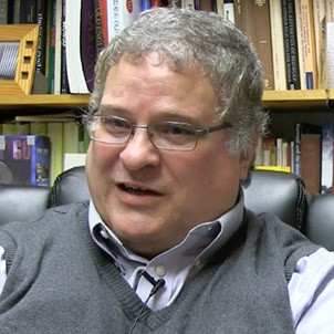 Dr. Larry Swain has clearly got Hobbit ancestry. His round cheeks, curly dark grey hair, and wire rimmed spectacles speak of jovial nights sitting up with philosophy flowing.