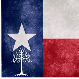 Texmoot Logo: the White tree with one Lone Star above it on a field of blue dexter. The Sinister field is divided per fess, white above and red below, in homage to the flag of the State of Texas.