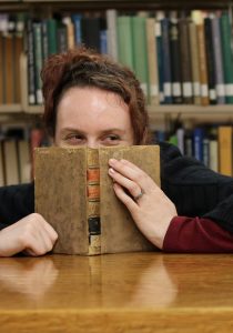 Laurel Stevens partially hidden behind a book