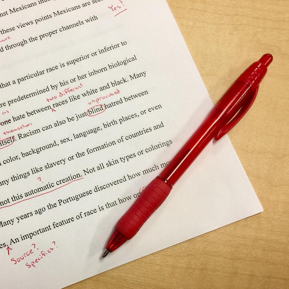 Printed text with edits made using a red pen